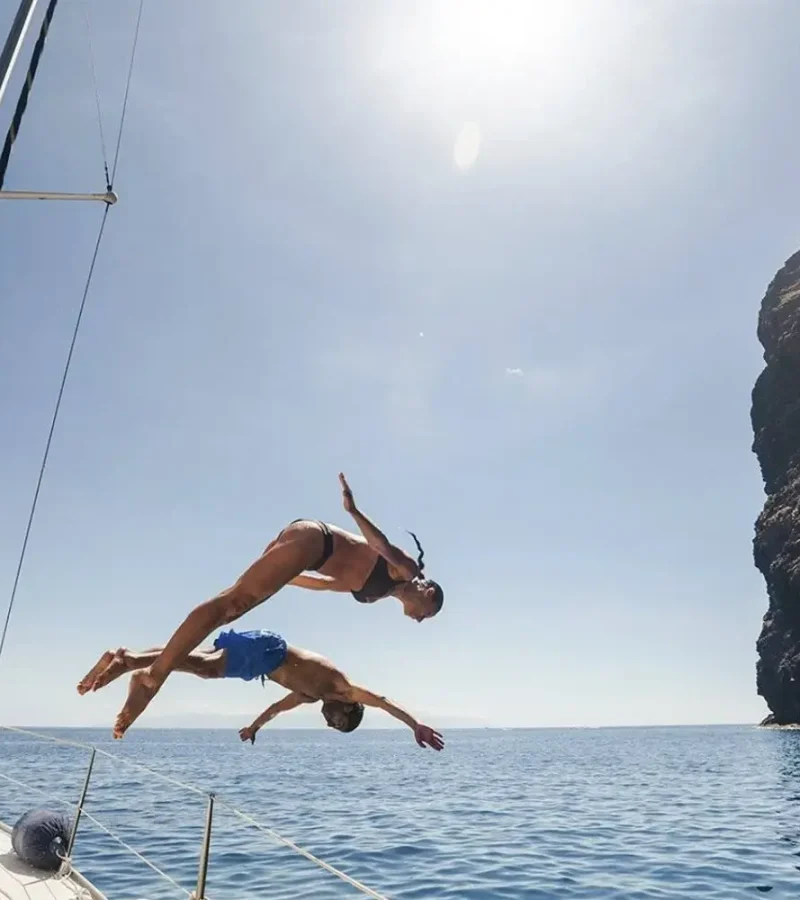 Customers jumping into the water from a boat in Tenerife